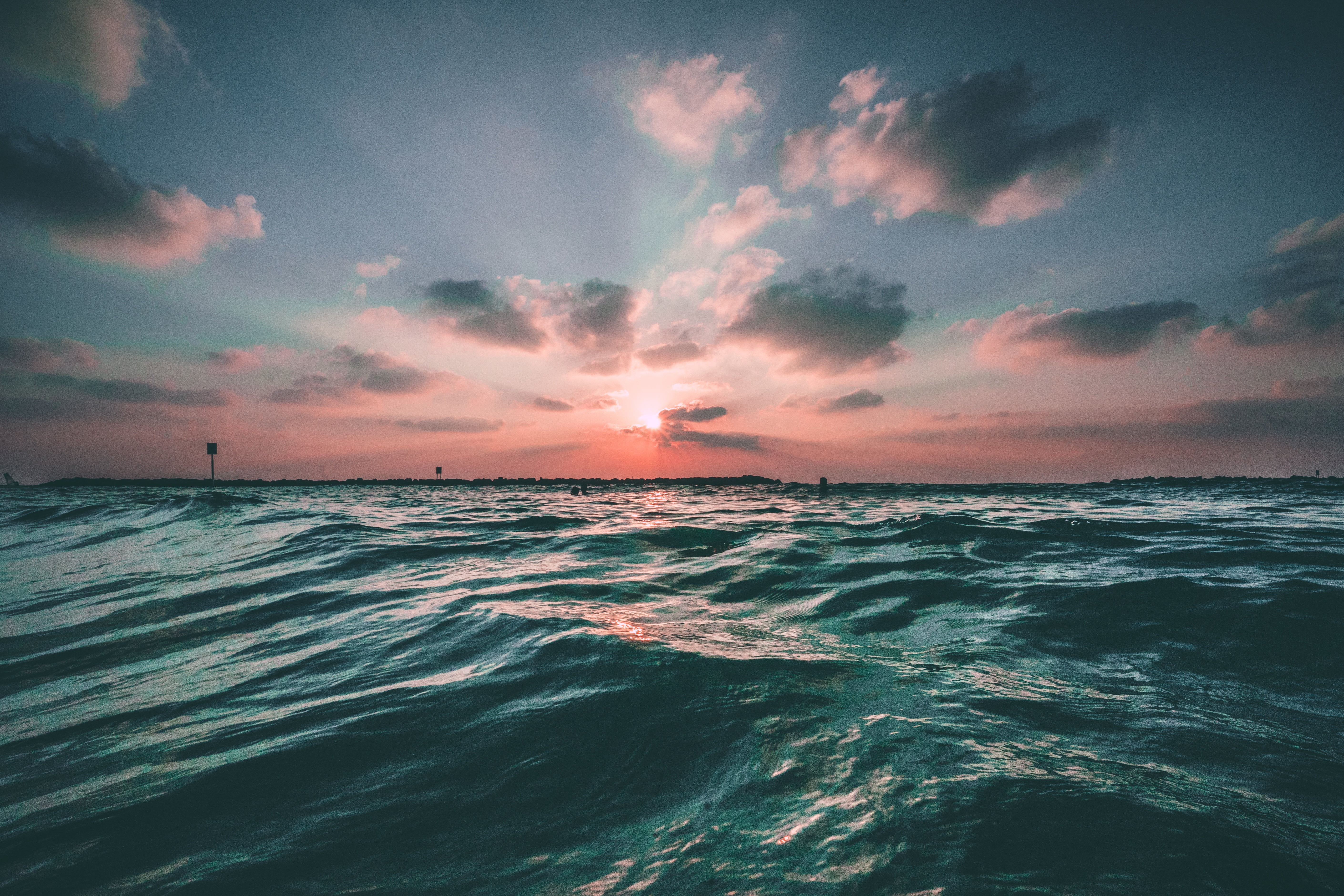 blue wave of deep blue sea under blue sky during daytime