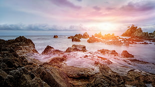 rock formation seashore during sun rise HD wallpaper