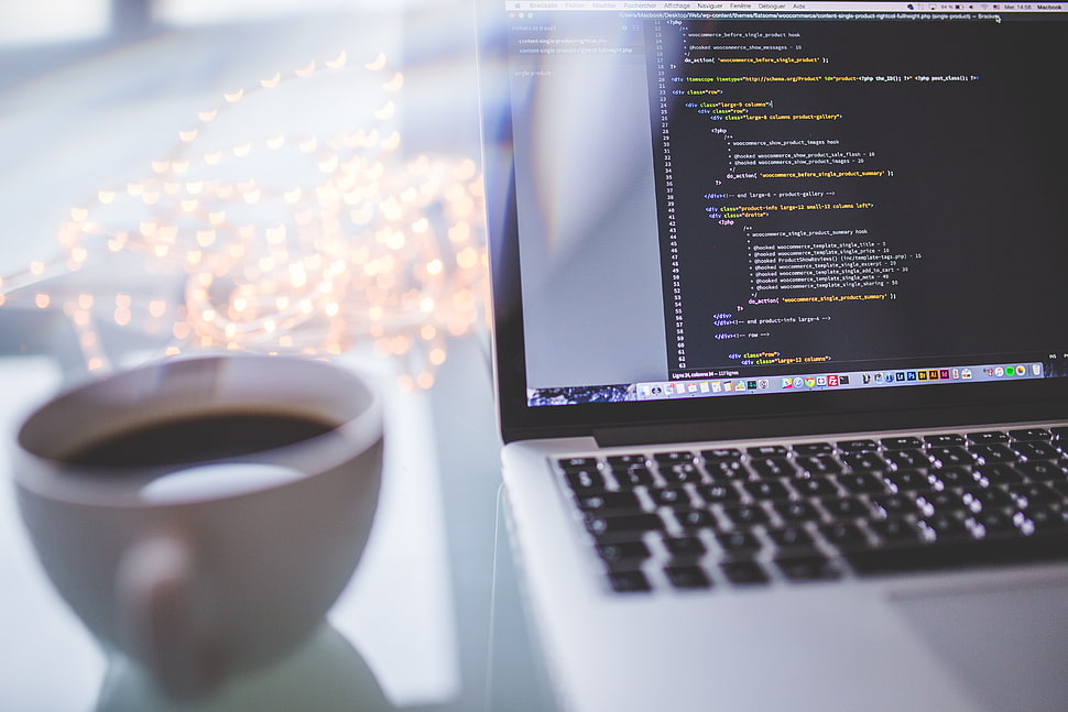 white coffee cup beside silver MacBook HD wallpaper