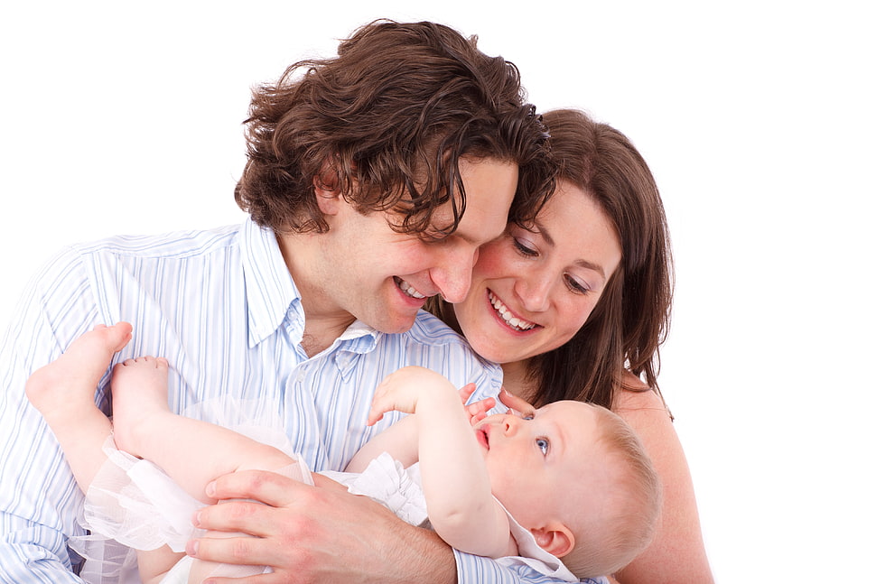 smiling couple cuddling their baby HD wallpaper