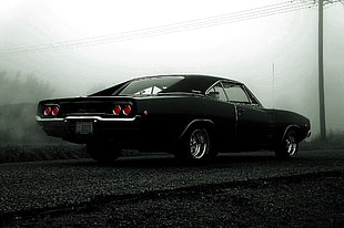 black coupe on black asphalt
