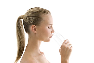 blonde haired woman drinking a glass of water