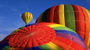 three hot-air balloons above ground