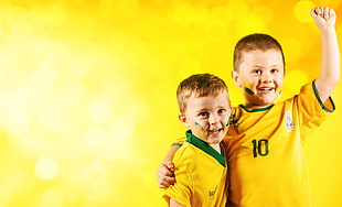 two boys in yellow-and-green jersey shirts HD wallpaper