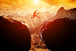 silhouette of man jumping between rock cliff artwork, jumping, landscape
