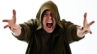 man wearing green pullover hoodie getting angry while opening his mouth