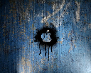apple logo spray paint on blue wall