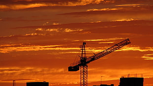 gray building crane at golden hour HD wallpaper