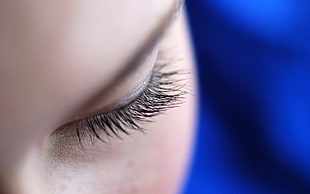 close up photo of a woman's left eyelashes and eyebrow