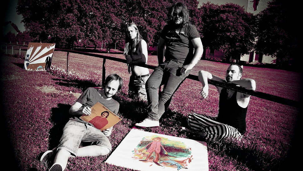 four men laying on red grass photo HD wallpaper