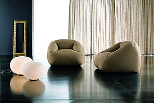 two bean bag chairs on black surface