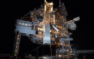 selective focus photography of gray metal structure with lights at nighttime