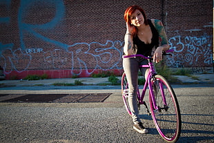 woman riding on purple bike