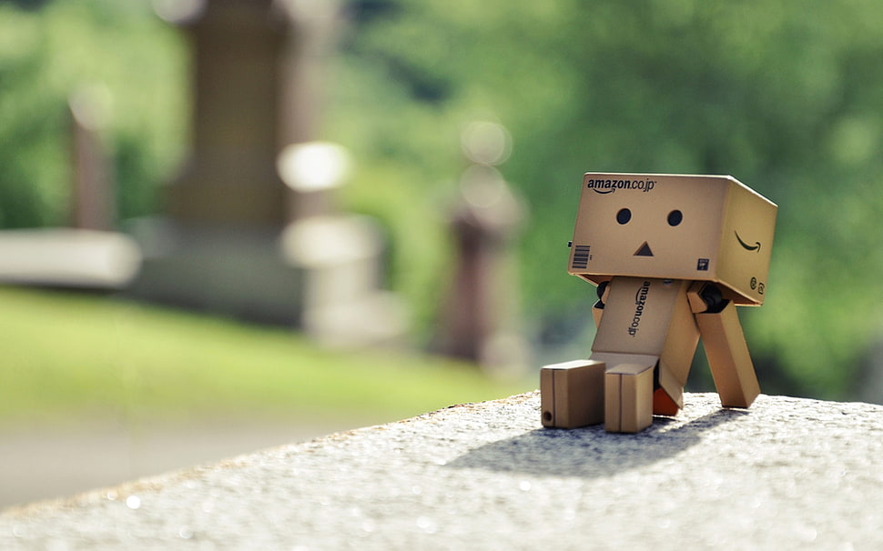 brown plastic toy sitting on the white surface HD wallpaper
