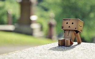 brown plastic toy sitting on the white surface HD wallpaper