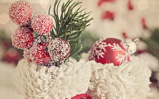 shallow focus photography of red and white Christmas baubles
