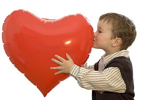 boy kissing red heart-shaped balloon