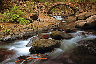 stream of water under bridge