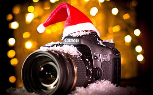 black Canon EOS 7D DSLR camera with red Christmas hat