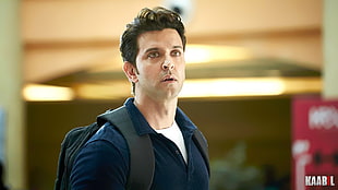 man wearing blue polo shirt closeup photography