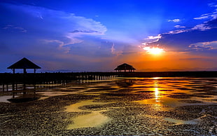 landscape photo of two cottage on body of water during golden hour HD wallpaper