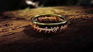 gold-colored ring with white text