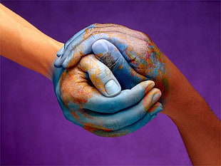 hands holding with teal skin paint photo, Earth