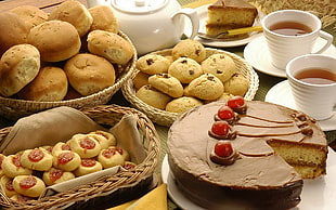 sliced cherry cake with cookies and breads