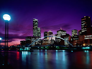 city buildings under blue and purple cloudy sky HD wallpaper