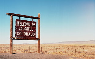 brown welcome signage, colorful, Colorado, desert, fence