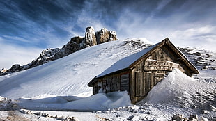 wooden house on snowy hill