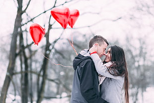 Two People With Heart Shape Balloons in Winter HD wallpaper