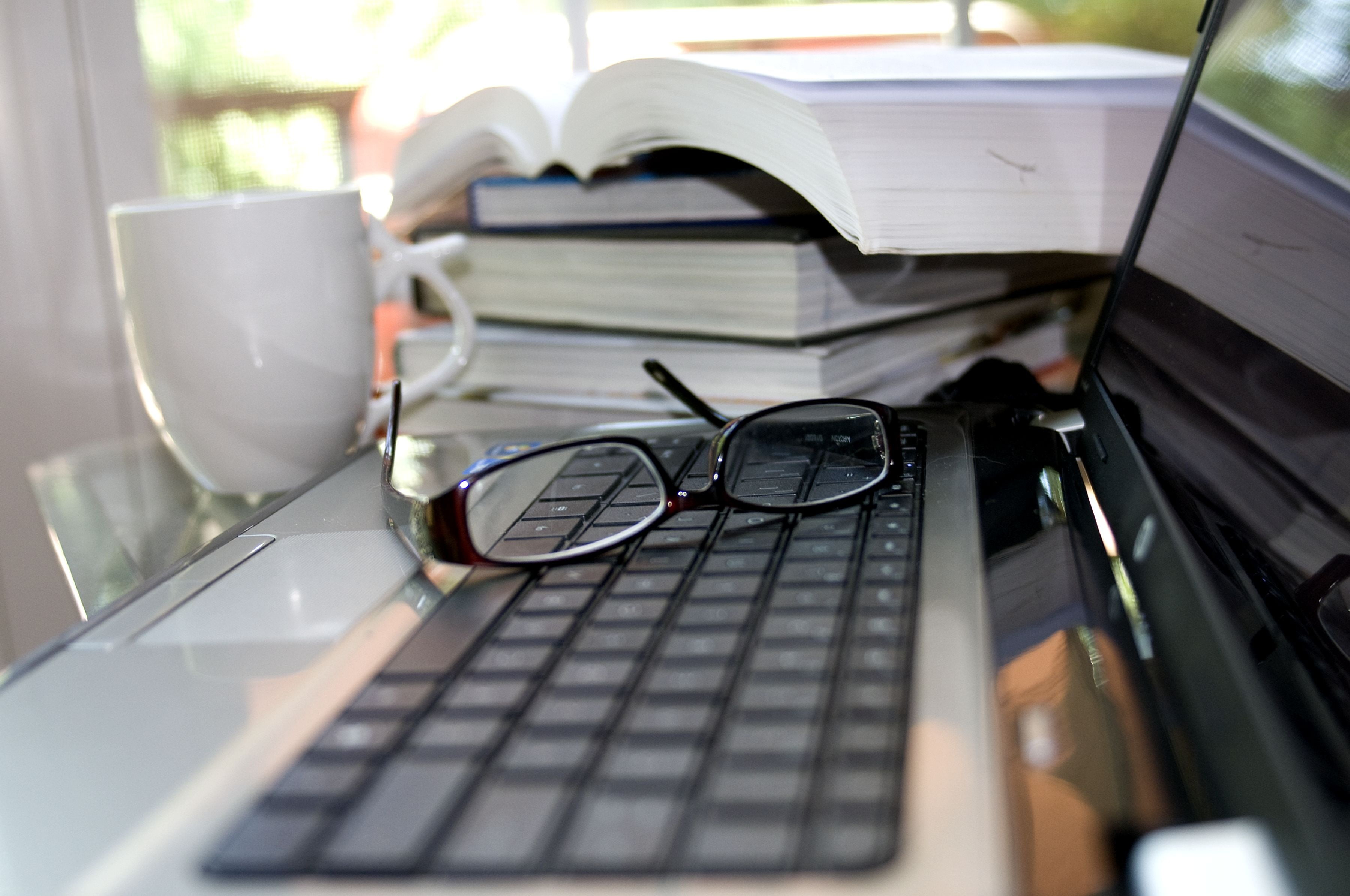 black framed eyeglasses on laptop