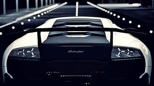 black and white Lamborghini sports coupe at nighttime