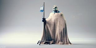 bearded man covered with cloth holding IV stand