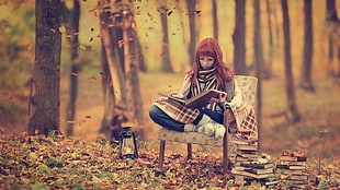 woman sits on white padded chairs reading book HD wallpaper