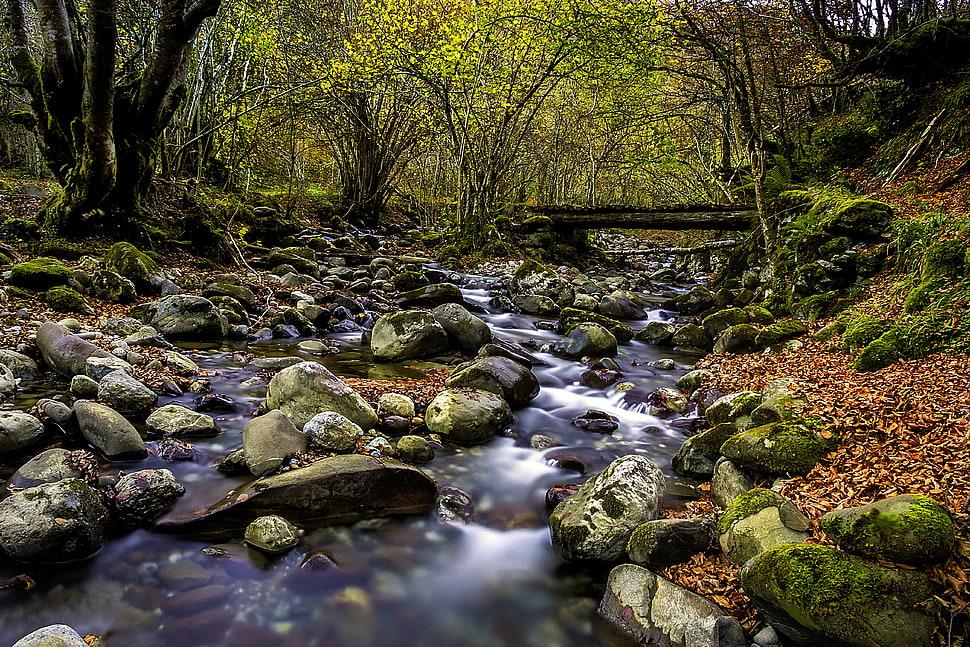 time lapse photography of river surrounded by stones HD wallpaper