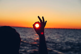 silhouette of right hand, nature, water, sunset