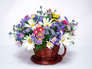 basket of white, purple and pink flowers