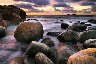 landscape photo of coastal rocks  during golden hour HD wallpaper