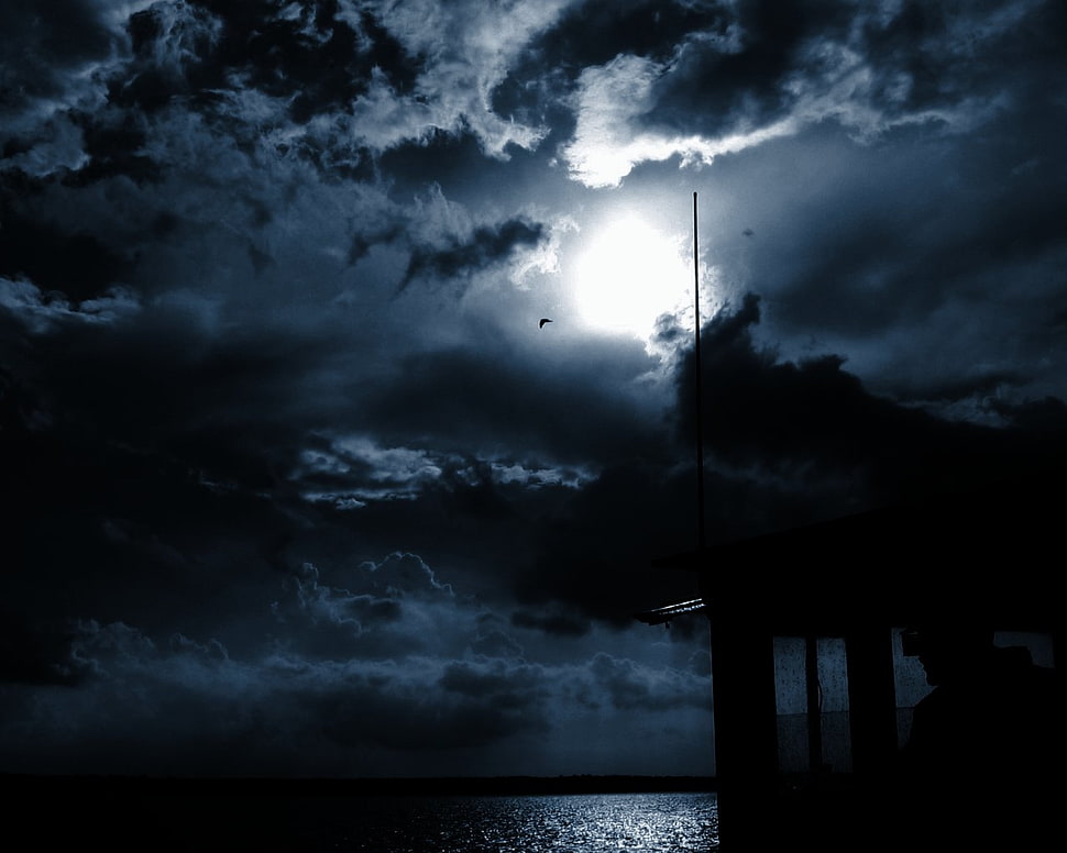 sea under moon on cloudy sky during night time HD wallpaper