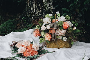 two white-peach-and-green petaled flower arrangements
