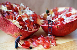 sliced fruit on brown wooden table, pomegranate