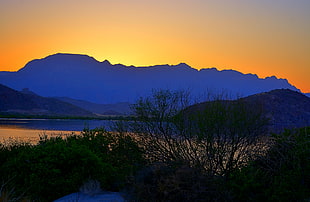 landscape photography of mountains and lake during golden hour, orange
