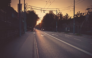 post on gray road during golden hours