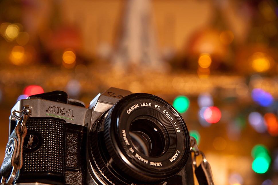 selective focus photography of black AE-1 camera with background of boke light HD wallpaper