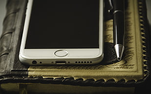 silver iPhone screen near pen