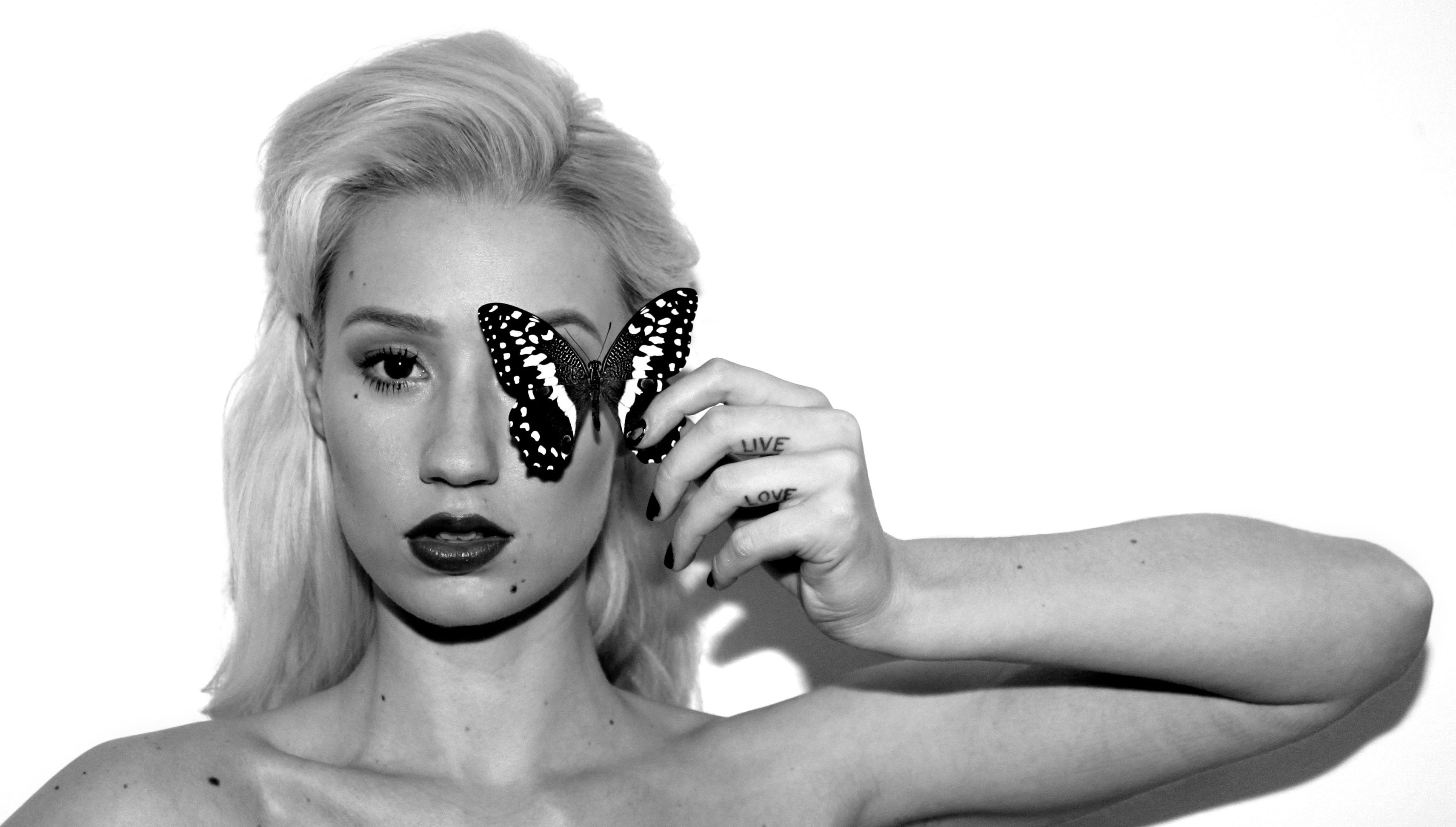 gray scale photo of woman covering her right eye with butterfly
