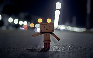 brown cardboard robot macro photo with blurred lights background HD wallpaper