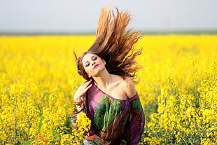 woman in purple off-shoulder top in the yellow flower field